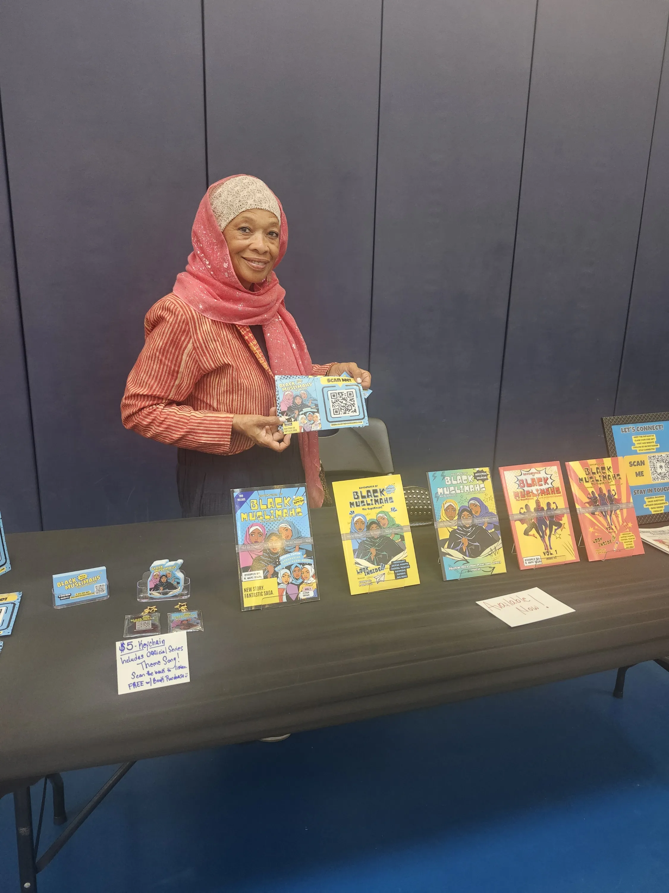 Ebony Reverie Comics founder S. Nuri Bilal with comic issues on display